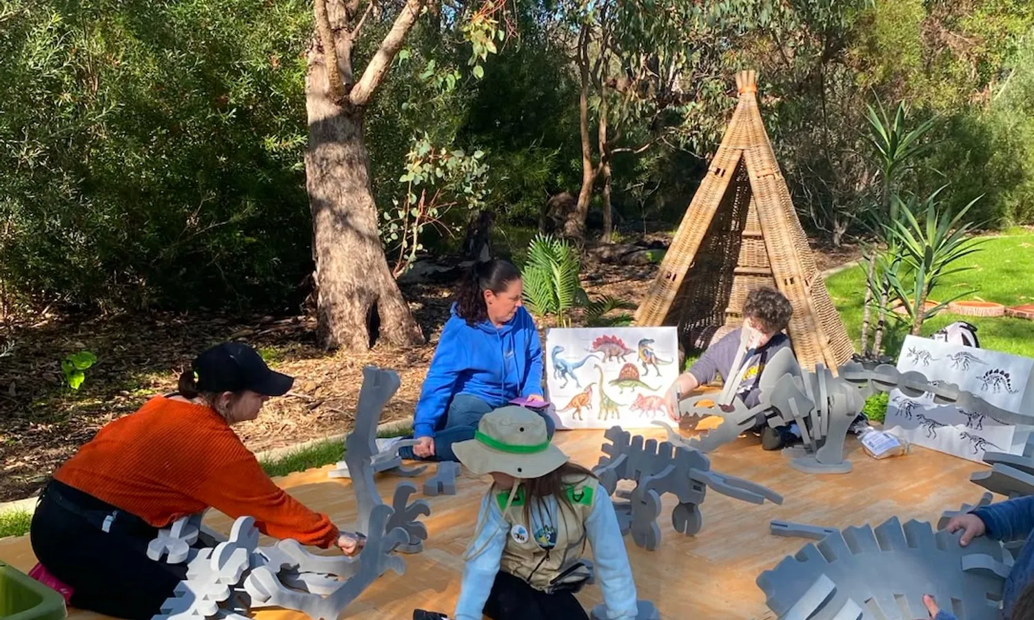 Children digging for dinosaur bones in a school sandpit